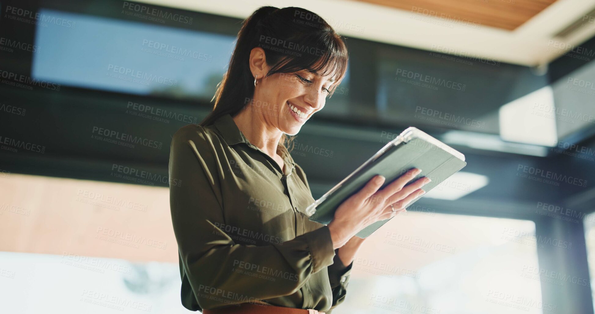 Buy stock photo Woman, realtor and smile with tablet, property management or service review in office. Below, mature estate agent and digital tech in agency for commission update, app scroll or thinking for research