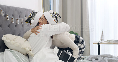 Buy stock photo Hug, couple and celebration in bed with Christmas, present and festive season for love in home. House, man and woman with gift in bedroom for embrace, smile and decoration for holiday bonding