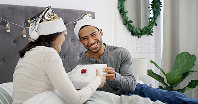 Buy stock photo Christmas, smile or couple in bed with gift, romantic moment or gratitude in xmas morning. Festive, happy or people in house with present, healthy relationship or appreciation in holiday tradition.