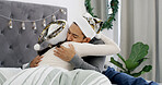 Christmas, couple and hug in bed with hat for holiday tradition, connection and appreciation in home. Married people, love and embrace in apartment for festive season, gratitude and bonding together.