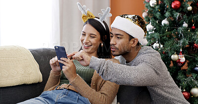 Buy stock photo Smile, couple and phone at house on Christmas for social media, gift search and browsing website. Happy, people and mobile for festive online shopping, present decision and ecommerce deals on xmas