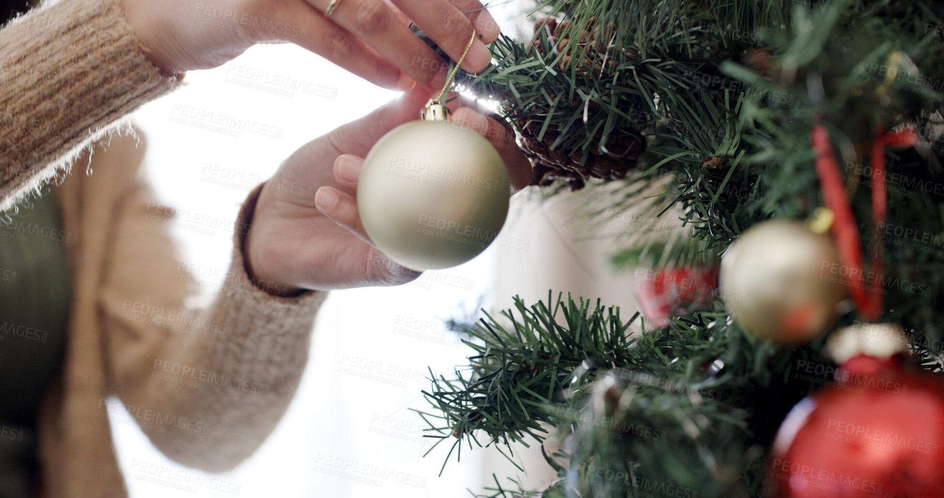 Buy stock photo Christmas, hands and person with decoration on tree for festive tradition, holiday season and celebration. December, home and woman with bauble, ornament and balls for xmas party, vacation and event