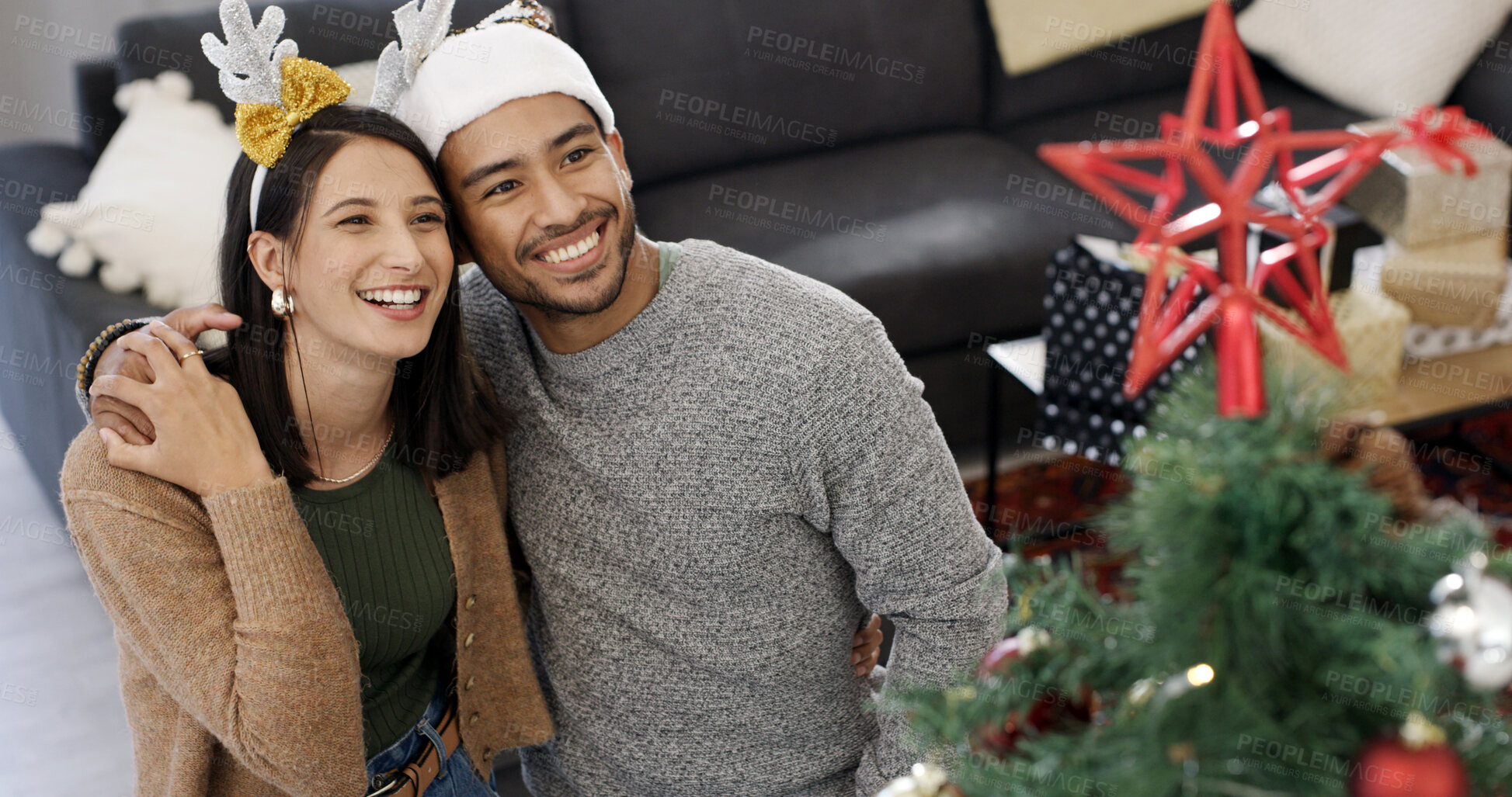 Buy stock photo Christmas tree, hug and couple with smile, home and bonding together with decoration. Xmas, man and woman in lounge, apartment and embrace with happiness, festive season and tradition with holiday