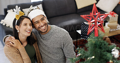 Buy stock photo Christmas tree, hug and couple with smile, house and bonding together with holiday. Xmas, man and woman in lounge, celebration and embrace with happiness, festive season and excited with tradition