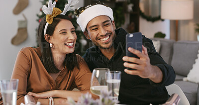 Buy stock photo Christmas, selfie or happy couple in lounge, social media post or profile picture update for holiday. Festive season, celebration or people with photography at dinner table for memory, smile or home