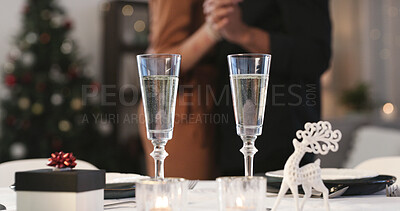 Buy stock photo Champagne, christmas and gift in dining room of home with couple dancing for festive tradition. Alcohol, glasses and present on table in apartment with dancer people bonding for holiday celebration
