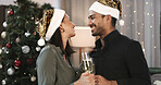 Christmas, happy couple or love in home with champagne for holiday tradition, care or bonding together. Married people, alcohol drink and smile in living room for festive season, connection and xmas.