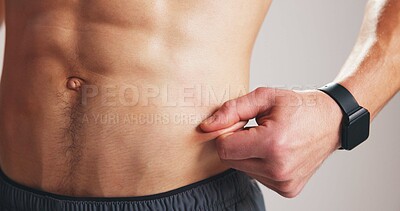 Buy stock photo Fitness, pinch abdomen or hand with body fat check, skin fold test or measure stomach slimming for progress. Results evaluation, track diet or man with weight loss for health, monitor size or studio