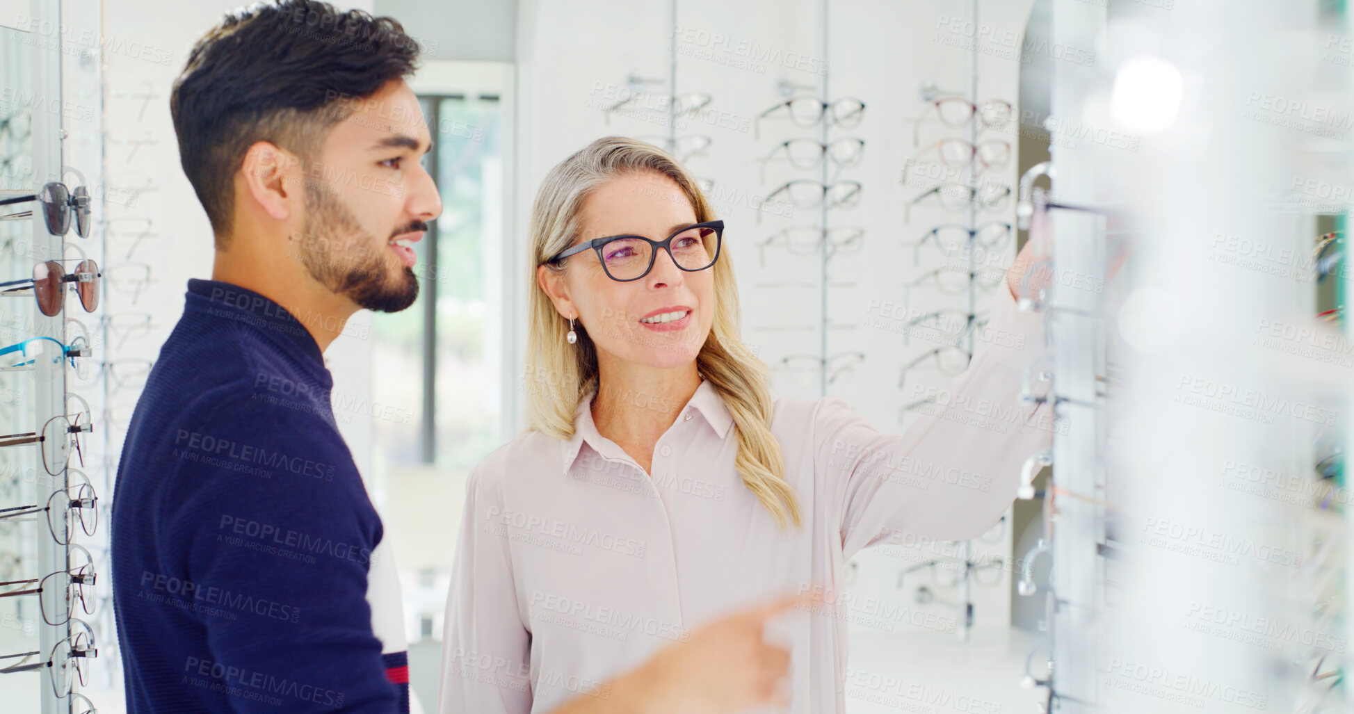 Buy stock photo Glasses, selection and woman with customer, store and choice for optical vision, eye care and shelf. Shopping, man and decision for prescription eyewear, options and purchase for eyesight or frame