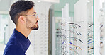 Health, man and shopping for glasses with mirror, vision and eyesight wellness with choice. Store, eyewear and person with frame for optometry decision, spectacles and customer with lens for eye care