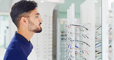 Buy stock photo Health, man and shopping for glasses with mirror, vision and eyesight wellness with choice. Store, eyewear and person with frame for optometry decision, spectacles and customer with lens for eye care