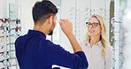 Optometry, glasses and man in store, woman and smile with medical consultation, clear vision or choice. Ophthalmology, customer and people with eyewear, prescription and spectacles with appointment