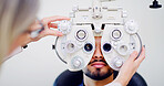 Optometrist, client or man with machine for eye exam, vision test or determine prescription for clear sight. Assessment, optometry or people with lens selection on phoropter, consultation or portrait