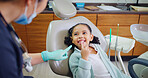 Happy, child and consultation with dentist in office for dental checkup, show cavity and extraction. Smile, kid and paediatric hygienist for oral health, teeth whitening and assessment for cleaning
