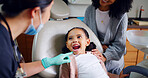 Child, mouth and consultation with dentist in office for dental checkup, show cavity and extraction. Mother, kid and paediatric hygienist for oral health, teeth whitening and inspection for cleaning