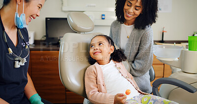 Buy stock photo Smile, kid and consultation with dentist in office for dental checkup, tooth extraction and hygiene. Mother, child and hygienist with lollipop of oral health, teeth whitening and cleaning services