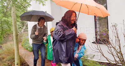 Buy stock photo Winter, umbrella and grandparents and children outdoor for rainy season, support and holding hands. Rain, generations and help with people and kids at family home for shelter and storm protection