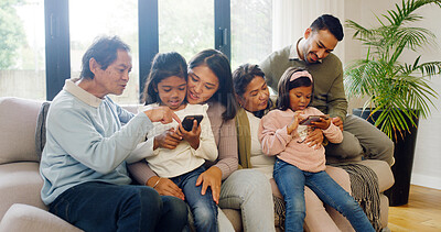 Buy stock photo Happy, cellphone and big family on sofa in home for bonding, connection and love on weekend together. Laugh, phone and children with grandparents and parents in living room for development in house.