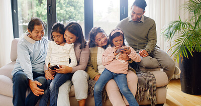 Buy stock photo Happy, technology and big family on sofa in home for bonding, connection and love on weekend together. Laugh, phone and children with grandparents and parents in living room for development in house.