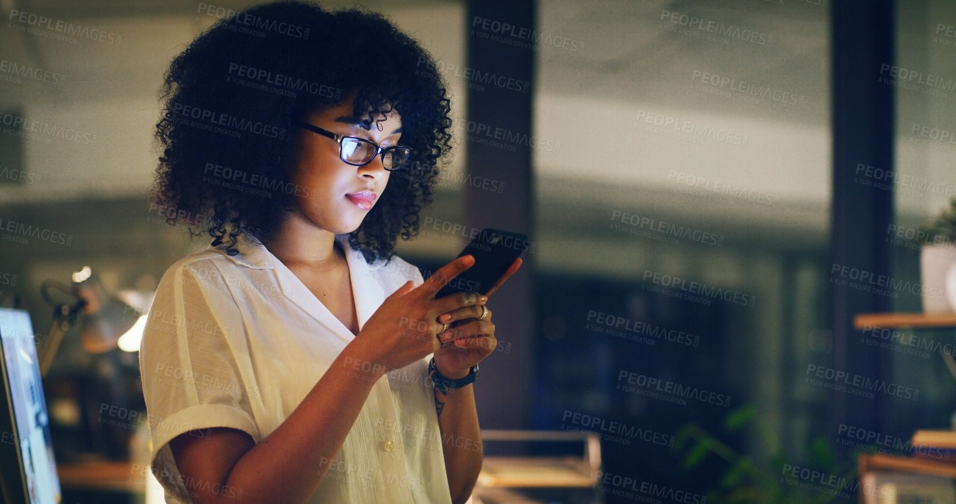 Buy stock photo Woman, smartphone and night at startup, texting or glasses with deadline for project at media company. Person, phone and review with app, scroll or check notification with overtime at digital agency