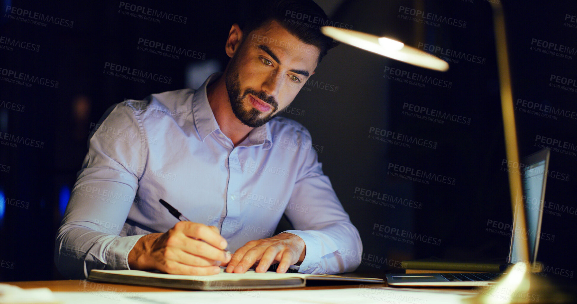 Buy stock photo Diary, writing and businessman in office at night with research for finance report with budget. Planning, corporate career and male financial manager working on investment proposal with deadline.