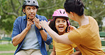 Bench, helmet and safety with family in park together for bonding, child development or fun. Getting ready, headwear or protection with mom, dad and daughter people outdoor for responsibility
