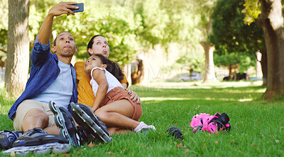 Buy stock photo Park, family and funny face for selfie with roller skates, social media post and silly parents. Mom, dad and picture with girl on skating break for goofy memory, relax and interracial people together