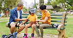 Parents, child and rollerblades on park bench with pads for  safety, fun activity and bonding together. Mom, dad and daughter outdoor with arm protection, helmet and getting ready for rollerblading.