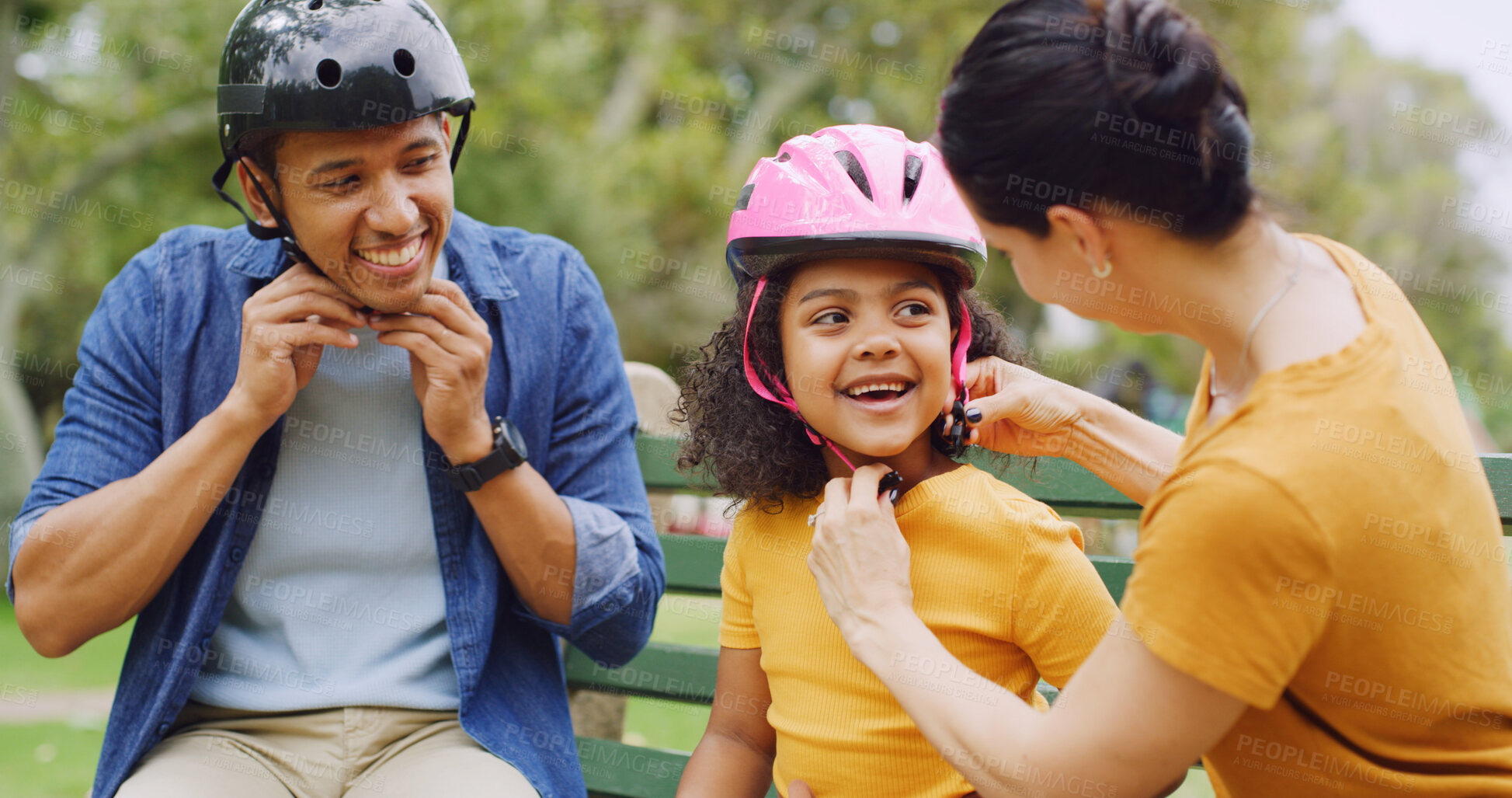 Buy stock photo Bench, helmet and safety with family outdoor together for bonding, child development or fun. Getting ready, headwear or smile with happy mom, dad and girl in park for protection or responsibility