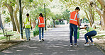 Volunteer, cleaning and group of people in park with bag to collect trash, plastic and litter for pollution. Outdoor, garbage and men and women for community service, recycling and environmental care