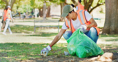 Buy stock photo Volunteer, cleaning and man in park with bag to collect trash, plastic and litter for pollution. Nature, waste and team of people outdoor for community service, recycling and environmental care