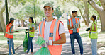 Volunteer, cleaning and portrait of man in park with bag to collect trash, plastic and litter for pollution. Outdoor, earth day and happy person for community service, recycling and conservation