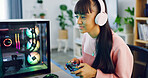 Woman, gaming and computer with controller for streaming, esports and online hobby in home. Headphones, gen z content creator and streamer with video game, tournament or internet challenge for vlog