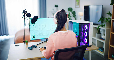 Buy stock photo Back of woman, gamer and computer with headphones for streaming, esports and online hobby in home. Mic, gen z content creator and streamer with video game, tournament or mockup space for vlog