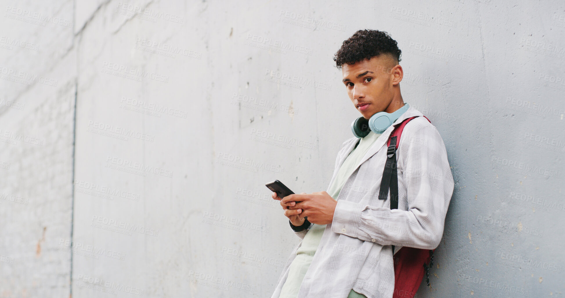Buy stock photo Phone, portrait and typing with teen boy in city for commute to high school destination. App, space and text message with student outdoor in urban town for break, education or mobile communication