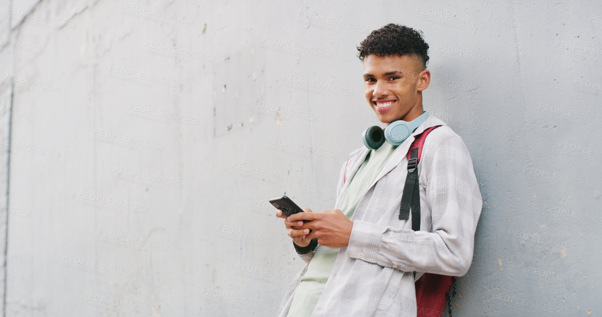 Buy stock photo Phone, portrait and smile with teen boy in city for commute to high school destination. App, mockup space and typing with happy student outdoor in urban town for break, communication or education