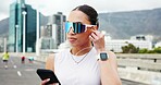 Woman, runner and phone with earphones in city, bridge and break with audio subscription for training. Person, smartphone and sunglass with mobile app, listen and streaming music with fitness routine