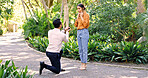Couple, surprise and proposal with ring outdoor for marry me gesture, engagement and save the date. Unexpected, people or partner with marriage promise, emotional reaction and relationship commitment