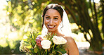 Flowers, wedding bride and happy woman at park for love, romance and celebration at special event. Smile, marriage and person with bridal bouquet, ceremony or outdoor in nature with portrait of bokeh