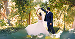 Couple, wedding and dance in forest, celebration and holding hands with smile, love and milestone. People, marriage and excited with commitment, relationship or happy outdoor with rhythm for event