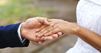 Buy stock photo Wedding ring, hands and couple outdoor for marriage, love symbol and commitment for celebration. Affection, people and closeup of bride and groom together for bonding, relationship or romantic event