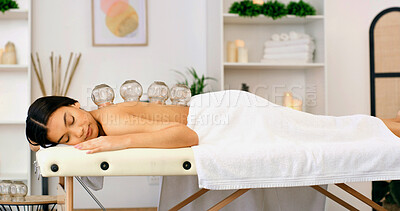 Buy stock photo Woman, healing or massage with cupping therapy for muscle tension or comfort in beauty spa. Calm, female person or relax with suction cups for stress relief, relaxation or Chinese medicine in salon
