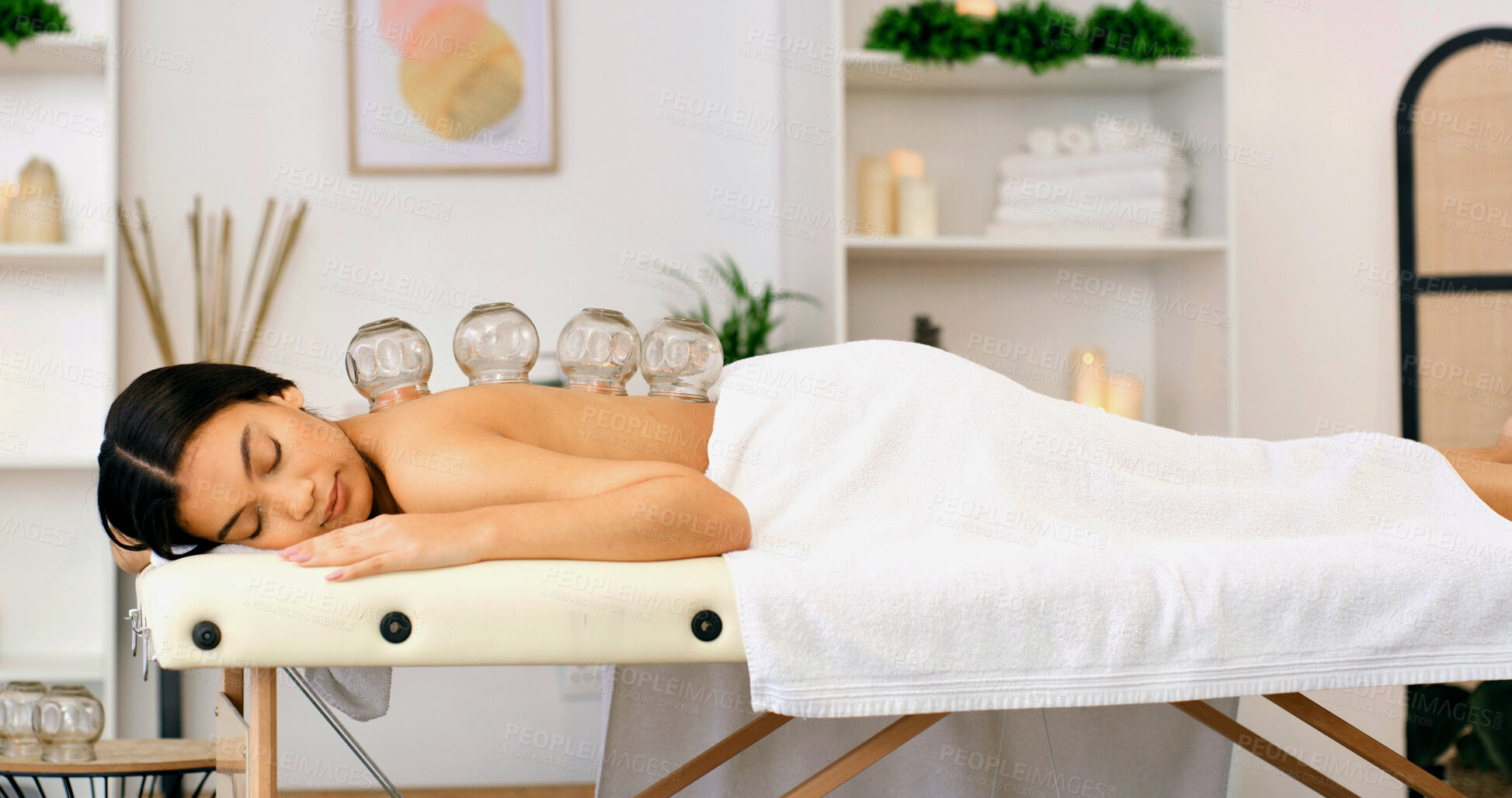 Buy stock photo Woman, healing or massage with cupping therapy for muscle tension or comfort in beauty spa. Calm, female person or relax with suction cups for stress relief, relaxation or Chinese medicine in salon