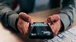Hands, phone screen and text message with business person at desk in office for communication. App, fingers and typing with employee in workplace for mobile chatting, post update or reply closeup