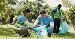 Team, volunteer and cleaning outdoor with trash bag for sustainability, conservation or ngo. Happy people, help and pick up garbage for community service, recycle or earth day with waste management