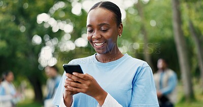 Buy stock photo Phone, black woman and volunteer in nature for networking, contact or social media post for outreach. Happy, outdoor and female ngo worker with cellphone for communication with community service.