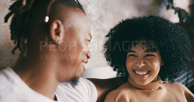 Buy stock photo Home, funny and couple with love, discussion and bonding together with smile, relax and romance. Laughing, happy man and woman on sofa, trust or relationship with comfort, marriage or conversation