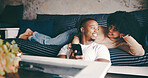 Hug, couple and relax with phone on sofa for online videos, social media post or weekend break. Love, african people and happy with smartphone in home for streaming subscription and bonding together