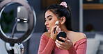 Ring light, woman and influencer with makeup brush for beauty, live streaming or tutorial. Cosmetics, apply powder and person recording video on phone for aesthetic, glow and broadcast change in home