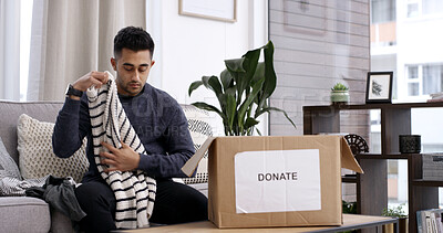 Buy stock photo Man, folding clothes and donation box in home for charity initiative, nonprofit and declutter closet. Person, package and apparel giveaway in house for NGO contribution, support and spring cleaning.